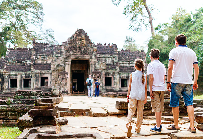 Family at ancient Preah Khan temple in Angkor Archaeological area in Cambodia